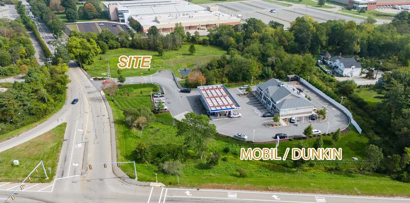Aerial view of the site behind the Mobil station and Dunkin' at the signalized intersection of Route 240 and Bridge Street